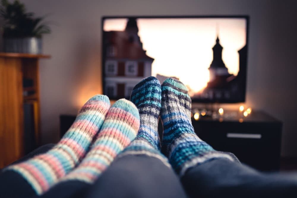 Two Pairs Of Socks Are Laying On A Couch In Front Of A Television — Coastwide Antennas In Gosford, NSW